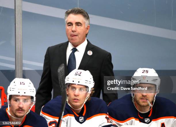 Head coach Dave Tippett of the Edmonton Oilers watches his team behind Josh Archibald, Tyler Ennis and Leon Draisaitl during the second period of the...