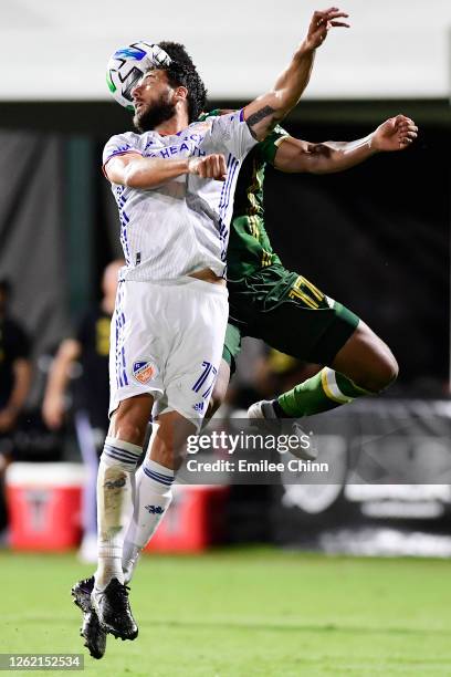 Mathieu Deplagne of FC Cincinnati and Jeremy Ebobisse of Portland Timbers jump to head the ball during a round of sixteen match in the MLS Is Back...