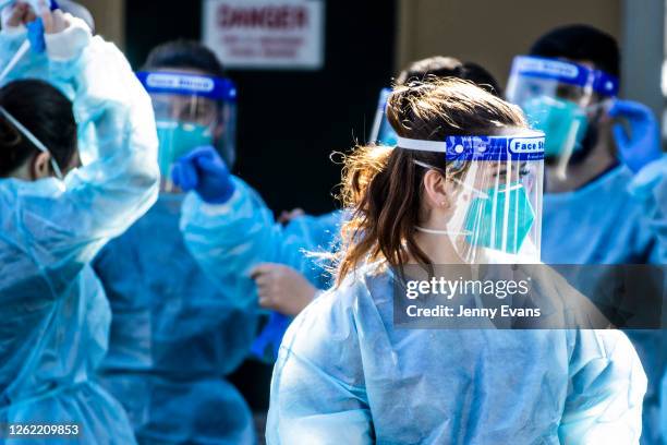 Health care workers are seen at a pop-up COVID-19 testing clinic in Rushcutters Bay on July 29, 2020 in Sydney, Australia. Effective August 1,...