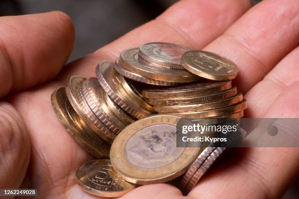 turkey - man holding turkish lira coins - turkish lira stock pictures, royalty-free photos & images