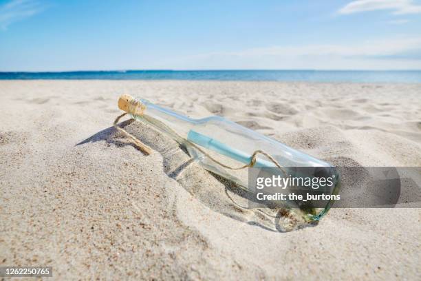 message in a bottle at the beach - important message stock pictures, royalty-free photos & images