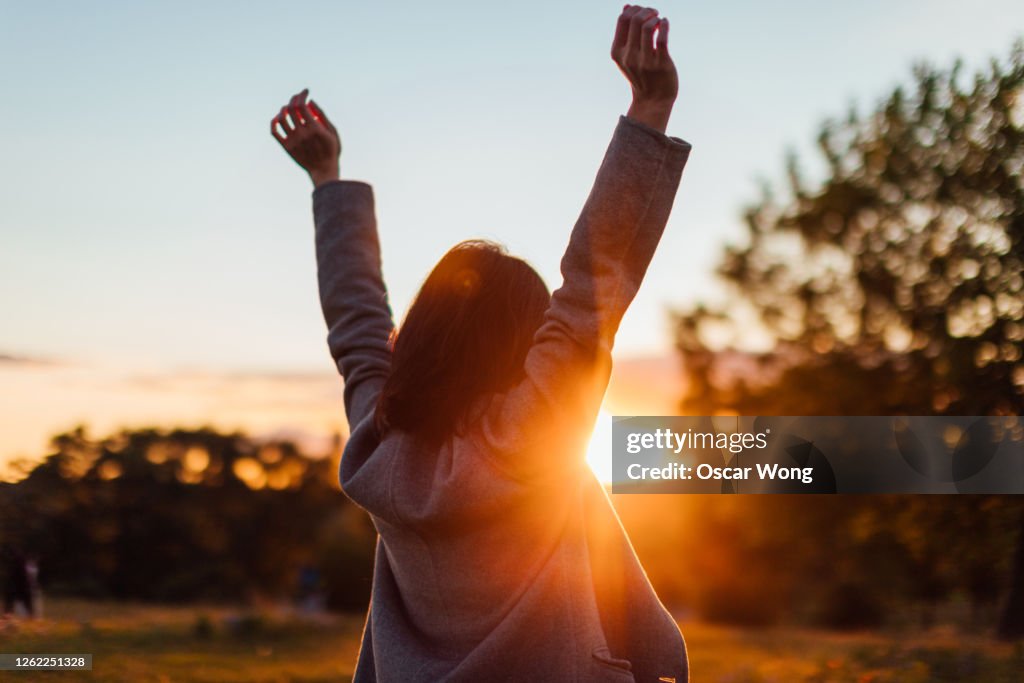 Young Woman Watching Sunset While Enjoying Nature