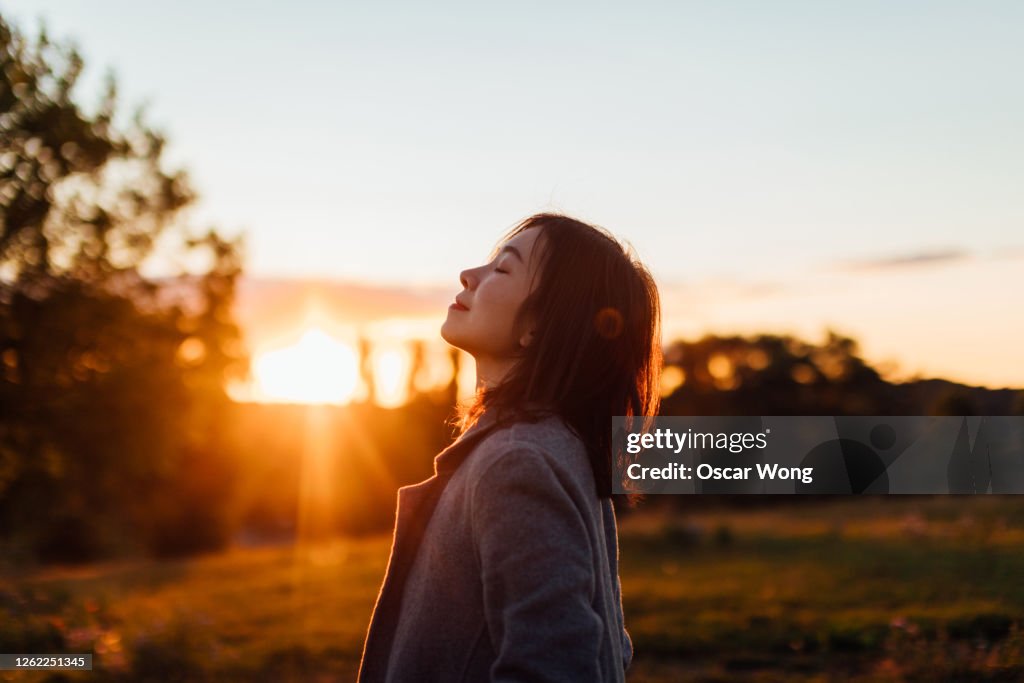 Young Woman Taking A Breath Of Fresh Air In Nature