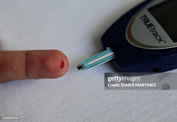 Blanca Morel A patient with diabetes monitors his blood glucose with a glucometer at a public hospital in Managua, on September 22, 2011. Diabetes is...