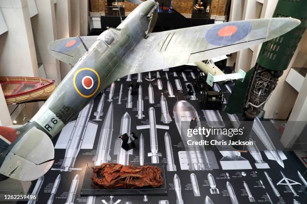 Woman looks up at The Supermarine Spitfire, as Ai Weiwei's "History Of Bombs" is unveiled at the re-opening of the Imperial War Museum on July 29,...