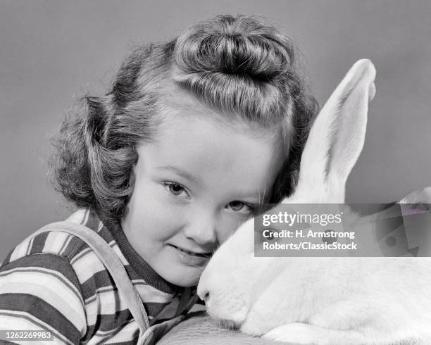 1940s Little Girl Looking At Camera Head To Head With A White Rabbit