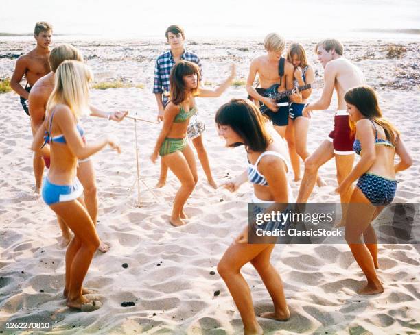 1960s 1970s Anonymous Band Teenage Musicians And Couples Boys And Girls Wearing Bathing Suits Dancing Together At A Beach Party