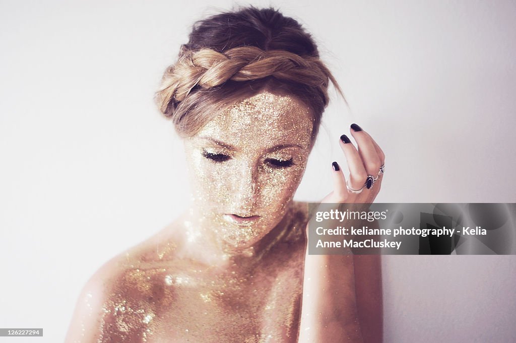 Girl with braid covered in gold glitter