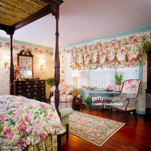 1990s Bedroom Interior Floral Chintz Fabric On Bedspread Wallpaper Border And Curtains Four Poster Canopy Bed Bureau Mirror