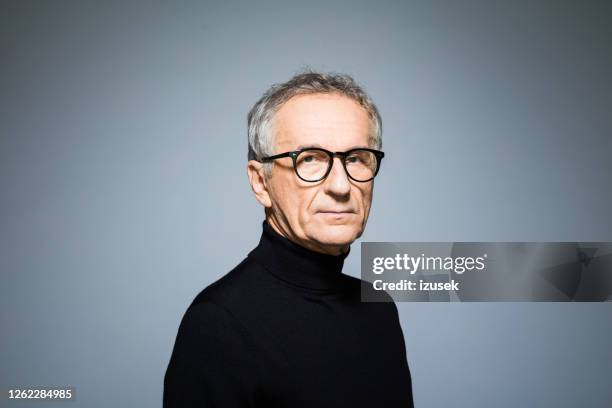 confident senior man wearing black turtleneck - white polo stock pictures, royalty-free photos & images