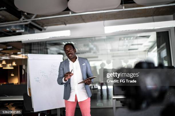 businessman recording a video in the office - teaching staff stock pictures, royalty-free photos & images