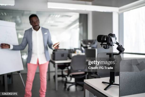 businessman recording a video in the office - virtual press conference stock pictures, royalty-free photos & images