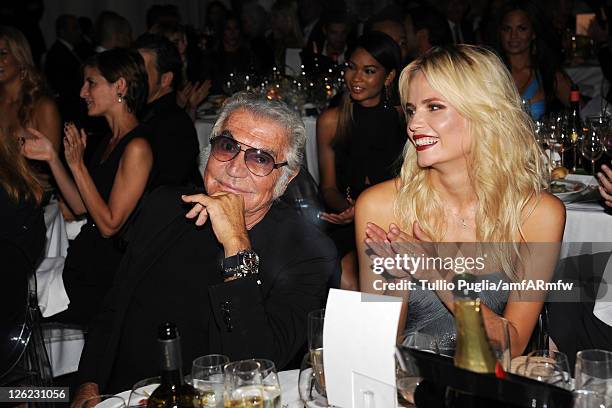 Designer Roberto Cavalli and Natasha Poly attend amfAR MILANO 2011 at La Permanente on September 23, 2011 in Milan, Italy.