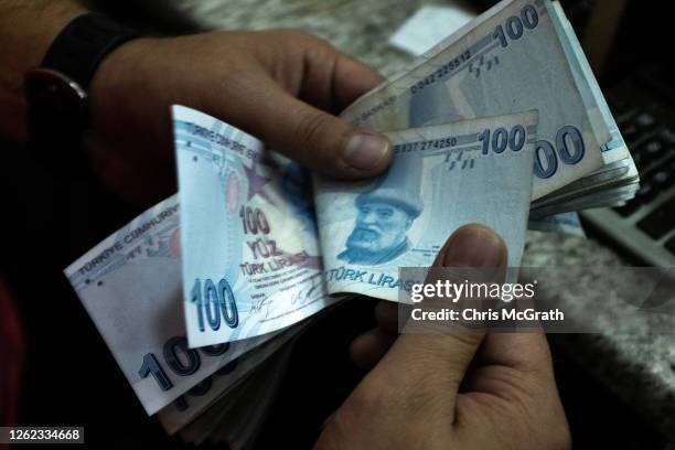 Detail as a man counts Turkish Lira at a currency exchange office on July 29, 2020 in Istanbul, Turkey. The Turkish Lira remains under pressure after...