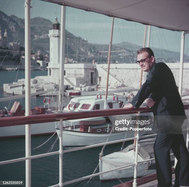 Rainier III, Prince of Monaco looks over the side of his luxury yacht moored in the harbour at Monte Carlo, Monaco in July 1954.