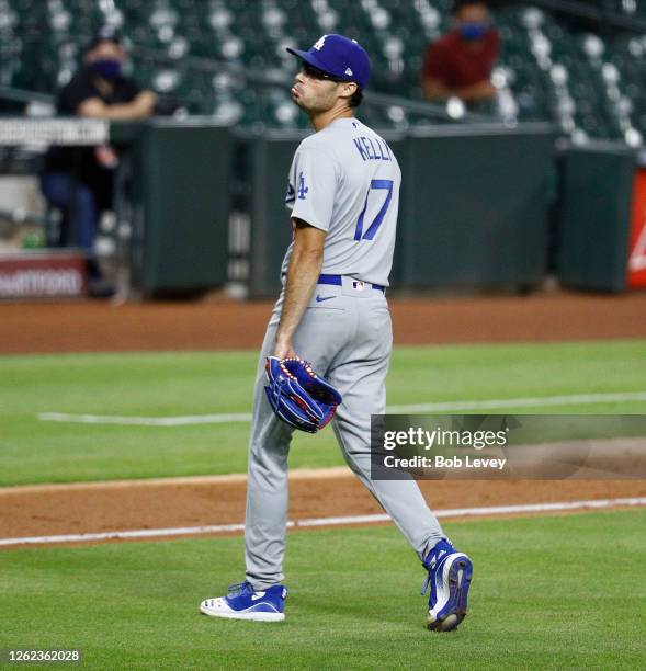 Joe Kelly of the Los Angeles Dodgers looks back at Carlos Correa of the Houston Astros in the sixth inning as they exchange words after he knocked...