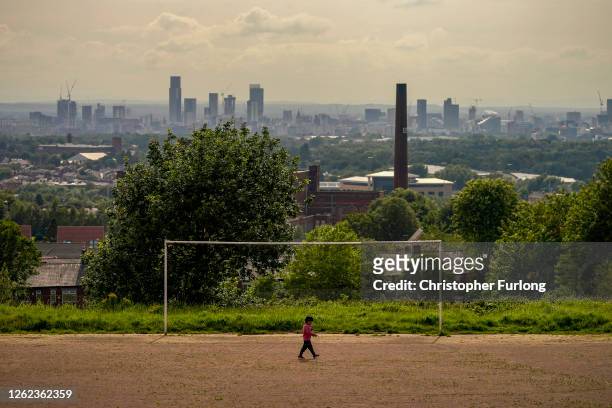 General view of an old cotton mill in Oldham with the city of Manchester on the horizon on July 29, 2020 in Oldham, England. Oldham Council is taking...