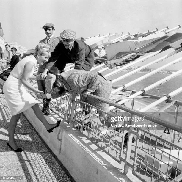 Sur la terrasse du Palais des Festivals, Charles Denner, Jean Rochefort, Michel Galabru et Jacqueline Huet, à Cannes, France le 2 mai 1964.