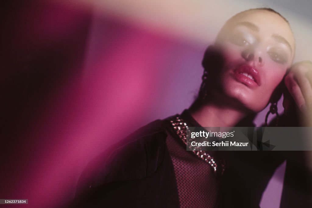 Young woman with shadow on face - stock photo