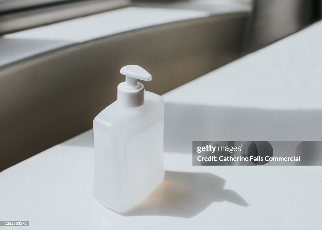 Simple image of Hand Soap on a plain white Surface. Space for copy.
