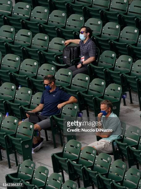 Theo Epstein president of baseball operations for the Chicago Cubs and Jed Hoyer executive vice-president and general manager watching the game...