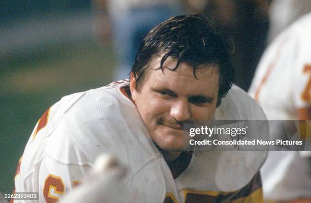 Close-up of American football player Dave Butz, of the Washington Redskins, as he sits on the bench during the preseason game at RFK Stadium,...