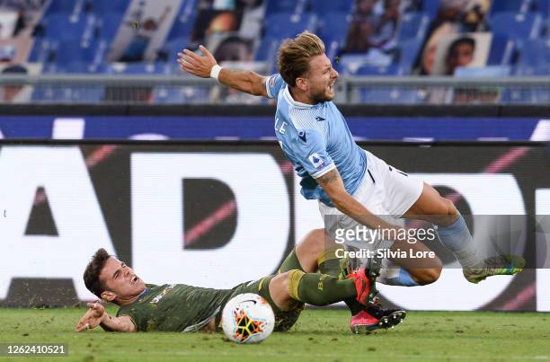 Andrea Papetti of Brescia Calcio tackles Ciro Immobile of SS Lazio during the Serie A match between SS Lazio and Brescia Calcio at Stadio Olimpico on...