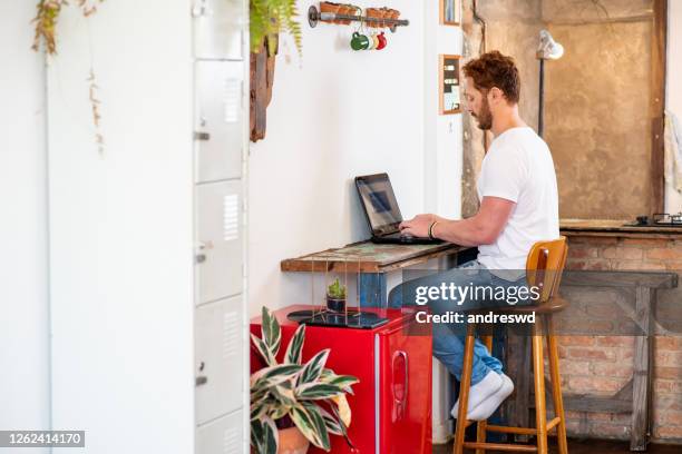 man working from home in new office - makeshift kitchen stock pictures, royalty-free photos & images