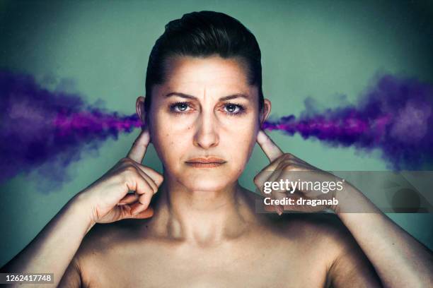 angry woman - woman fingers in ears stock pictures, royalty-free photos & images