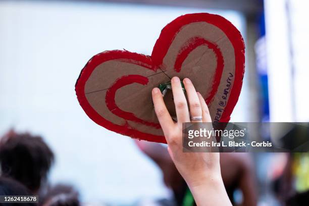 July 26: A protester holds a hand painted sign of hearts in Times Square New York in support of Black Women. On July 28, 2020 Nikki Stone a homeless...