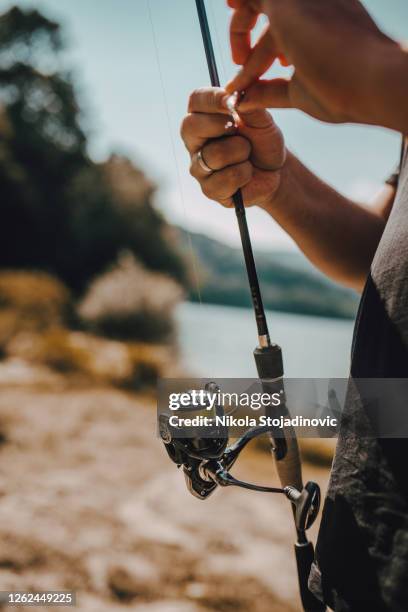 the fisherman prepares the hook - freshwater fishing stock pictures, royalty-free photos & images