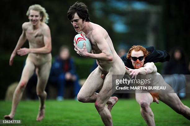Player of the Nude Blacks is tackled by a player of Romanian Vampires, on September 24 at Larnach castle in Dunedin, during the 2011 Rugby World Cup....
