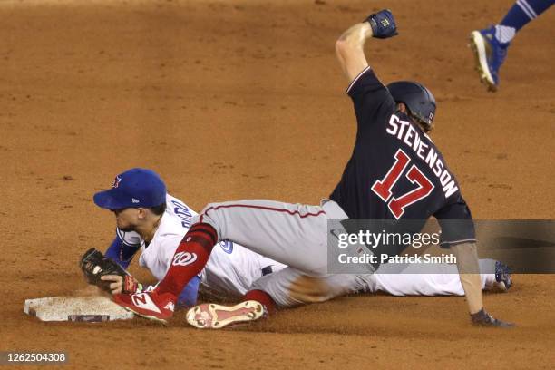 Andrew Stevenson of the Washington Nationals slides into second base safe to beat the force out by Cavan Biggio of the Toronto Blue Jays during the...