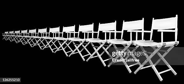 row of white directors chairs on black background - film director chair stock pictures, royalty-free photos & images