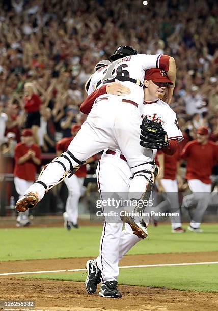 Relief pitcher J.J. Putz of the Arizona Diamondbacks celebrates with catcher Miguel Montero after defeating the San Francisco Giants and clinching...