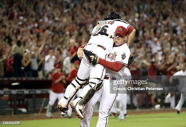 Relief pitcher J.J. Putz of the Arizona Diamondbacks celebrates with catcher Miguel Montero after defeating the San Francisco Giants and clinching...