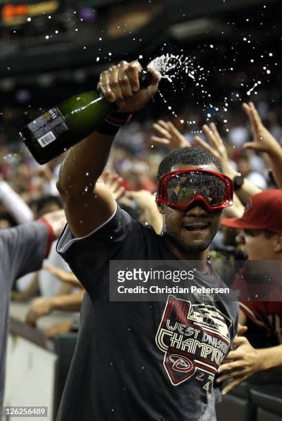 Chris Young of the Arizona Diamondbacks celebrates with champagne after defeating the San Francisco Giants and clinching the National League West...