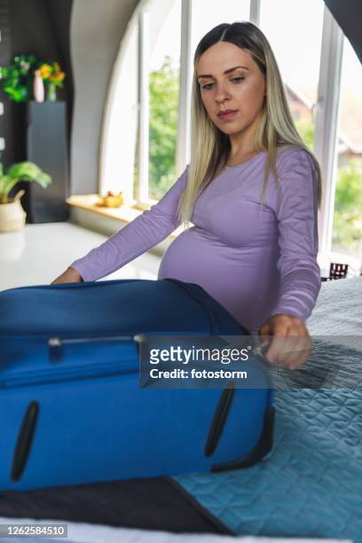 pregnant woman finished packing and ready to go to hospital to have a baby - waiting list stock pictures, royalty-free photos & images