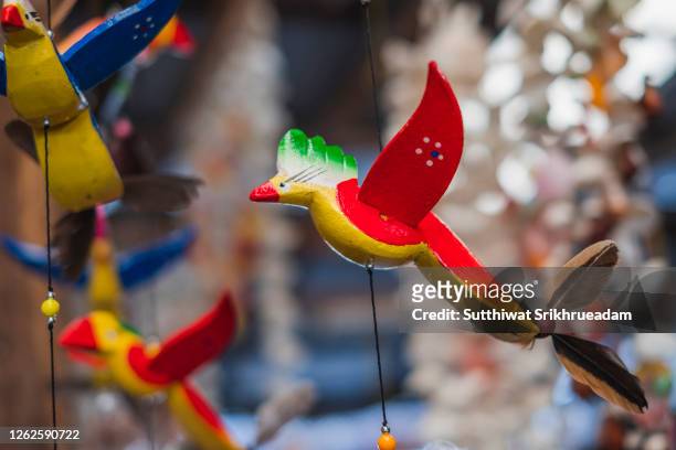 close-up of hanging beautiful bird mobile - using mobile stockfoto's en -beelden