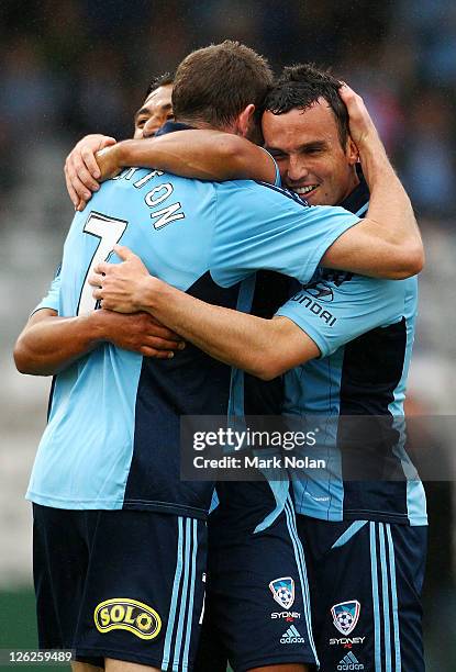 Nick Carle, Brett Emerton and Mark Bridge of Sydney celebrate a goal by Nick Carle during the A-League pre-season match between Sydney FC and Perth...