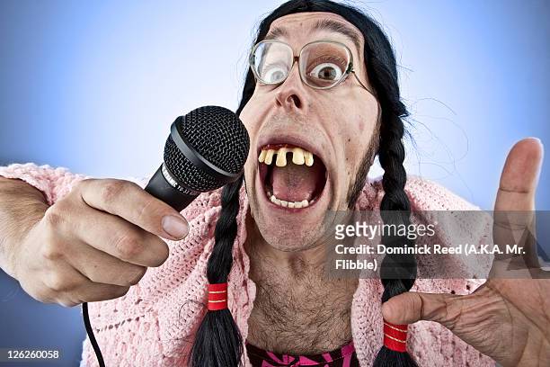 ugly lady singing into microphone - ugly woman stock pictures, royalty-free photos & images