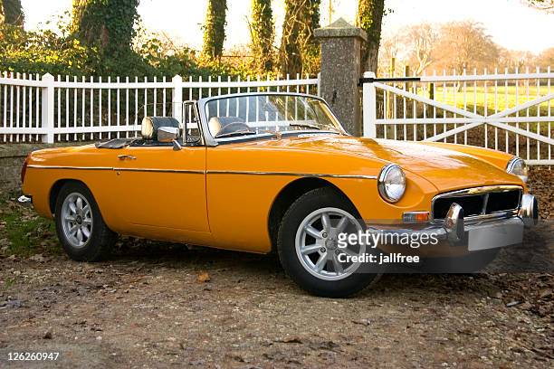 old yellow 1970’s classic british sports cars - vintage car stockfoto's en -beelden
