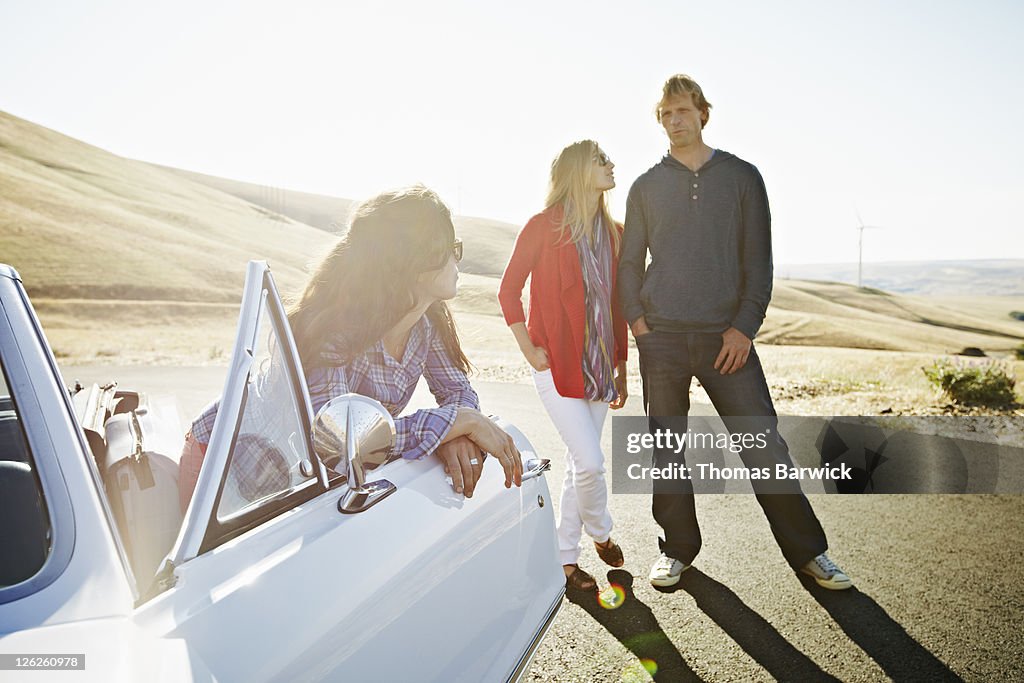 Couple in discussion with woman