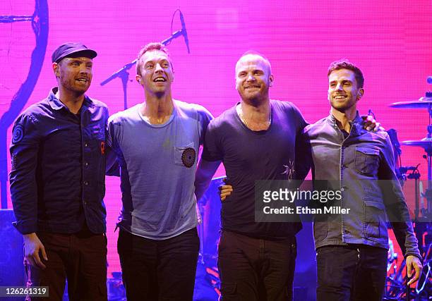 Musicians Jonny Buckland, Chris Martin, Will Champion and Guy Berryman of the band Coldplay pose onstage at the iHeartRadio Music Festival held at...