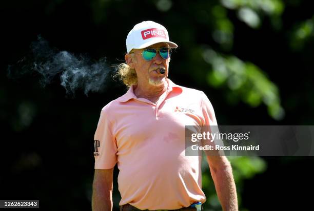 Miguel Angel Jimenez of Spain is seen smoking a cigar while on the practice chipping area during Day One of the Hero Open at Marriott Forest of Arden...