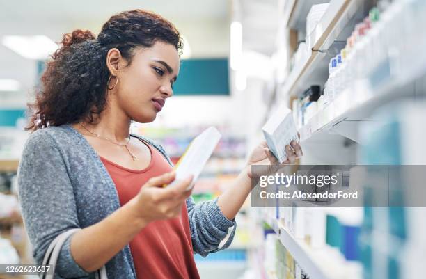 navigating the minefield of medication - pharmacy aisle stock pictures, royalty-free photos & images