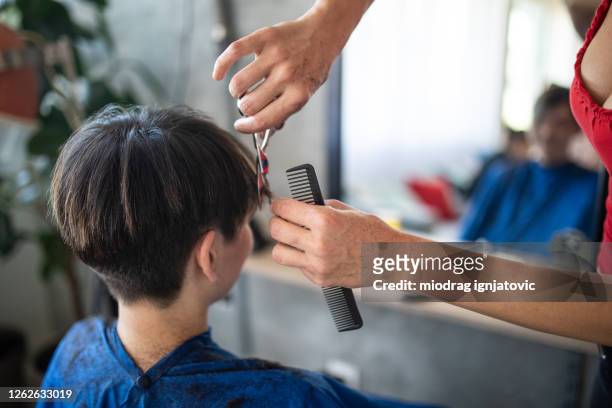 female hairstylist cutting woman's short hair with scissors in hair salon - short hair cut stock pictures, royalty-free photos & images
