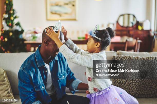 father playing dress up with his little daughter at home - tutu stock pictures, royalty-free photos & images