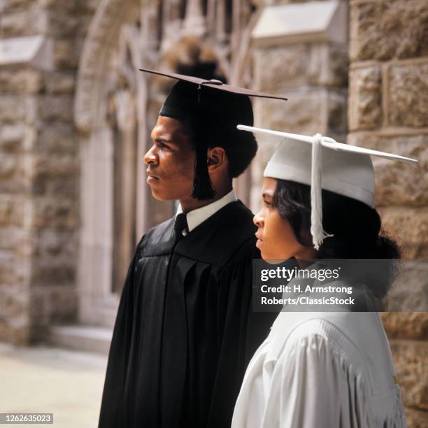 1970s African-American College University Graduates Man And Woman In Profile Wearing Graduation Robes And Caps