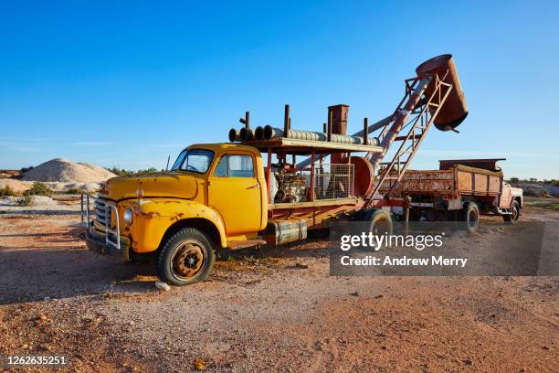 old mining vehicles, trucks in outback, desert landscape, white cliffs, australia - country town australia stock pictures, royalty-free photos & images